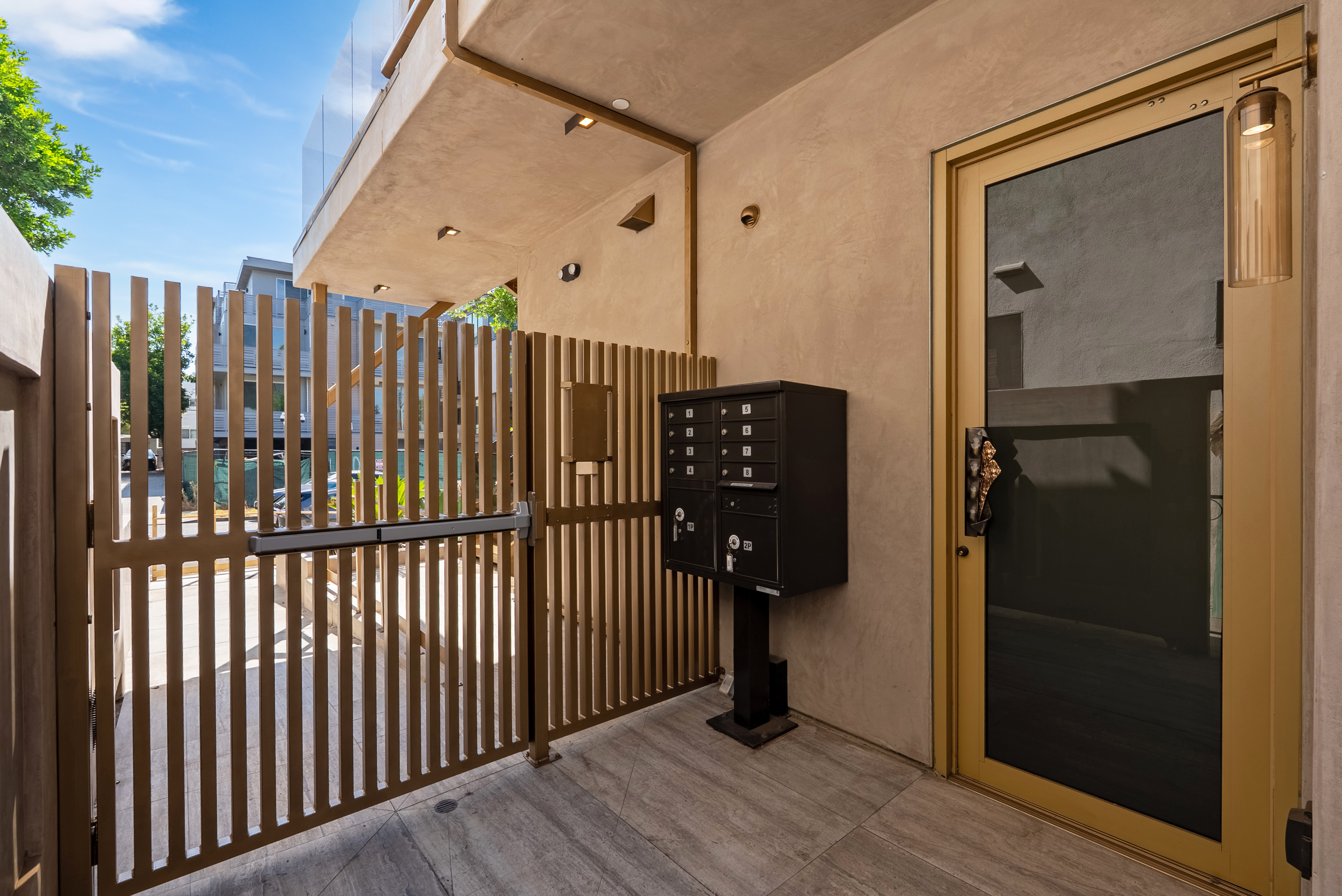 Secured entry vestibule with keyed mail center and controlled-access door
